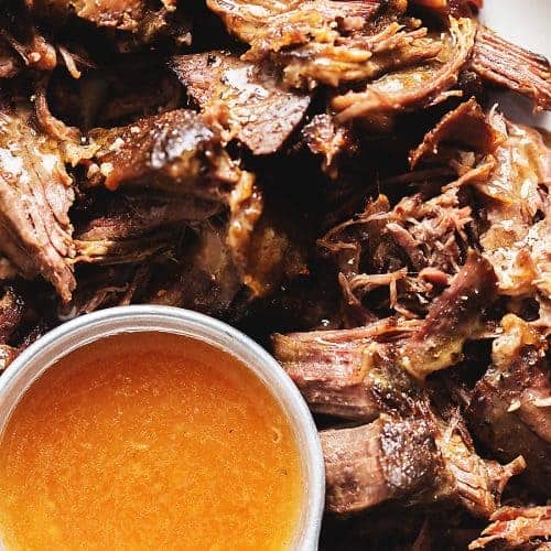 shredded pot roast with a measuring cup of gravy