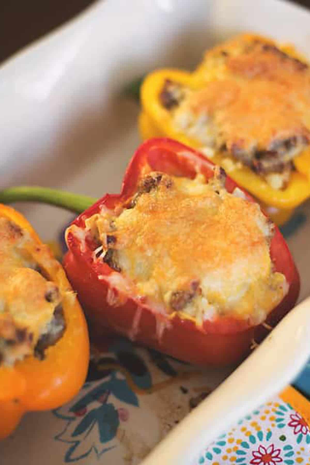 stuffed peppers in a colorful casserole dish