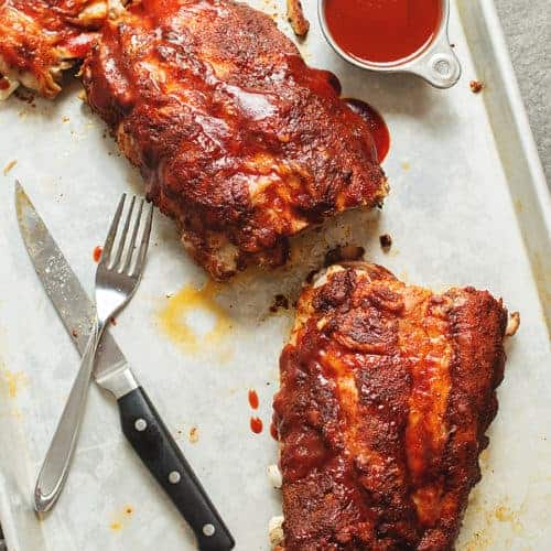 BBQ ribs on a sheet pan with sauce