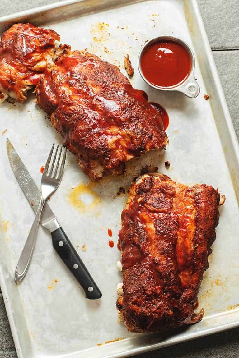 BBQ ribs on a sheet pan with sauce