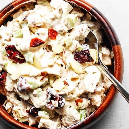 chicken salad with cranberries and almonds in a wooden bowl