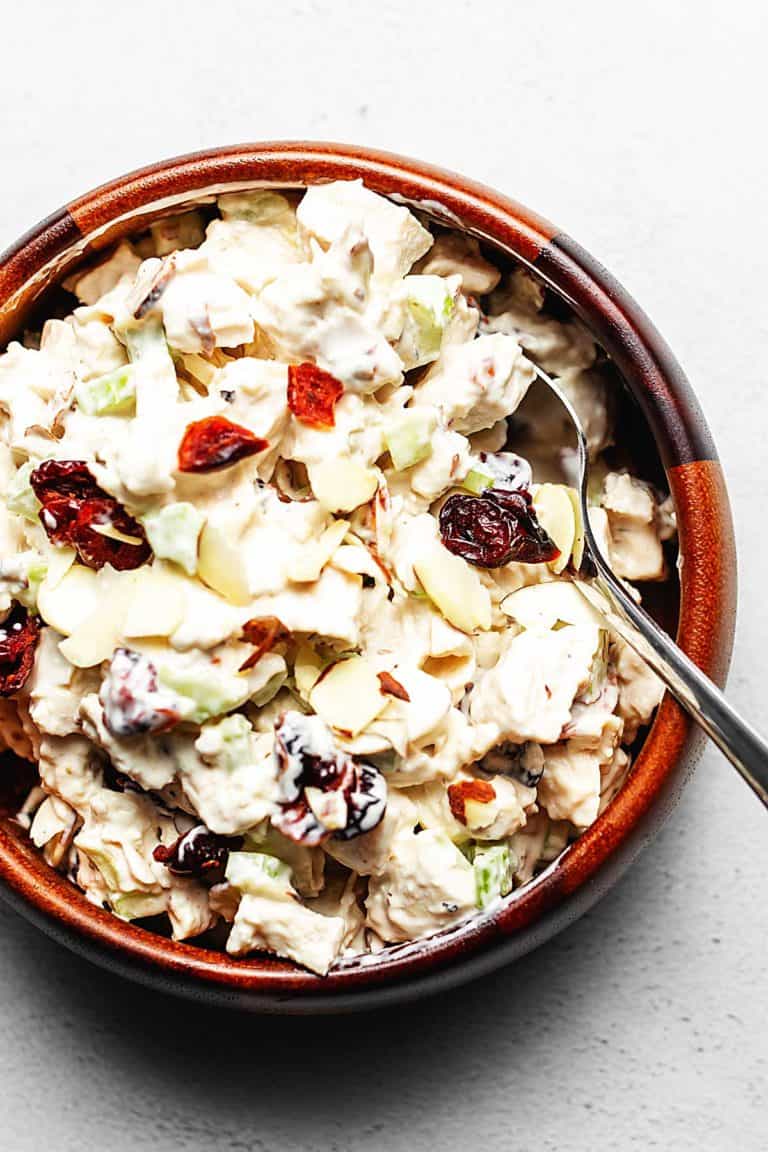 chicken salad with cranberries and almonds in a wooden bowl
