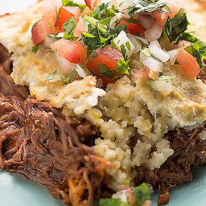 This low carb tamale pie is so full of flavor and gluten free! Saucy shredded beef, melty cheese, and a low carb "cornbread" crust.
