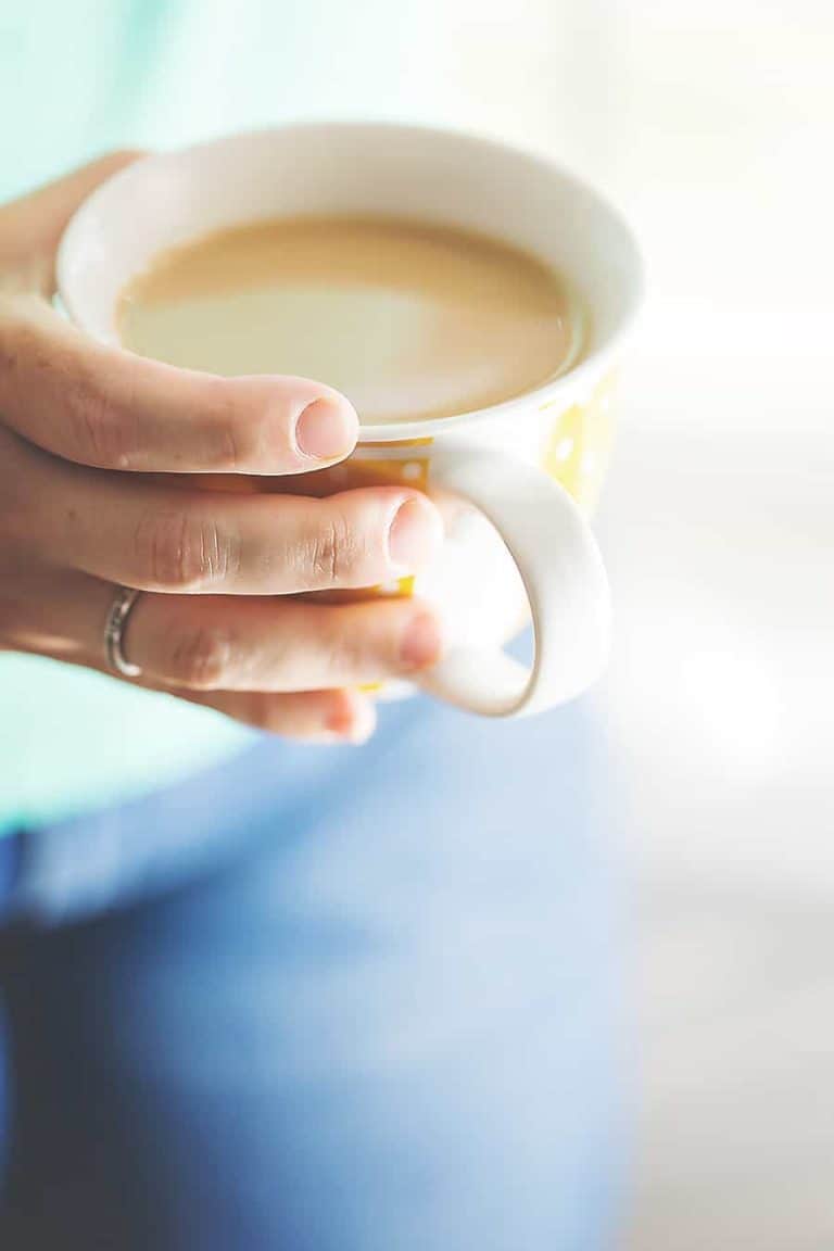 someone holding a mug full of bulletproof coffee