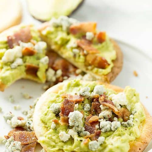 mashed avocado on oopsie rolls with bacon and blue cheese on top