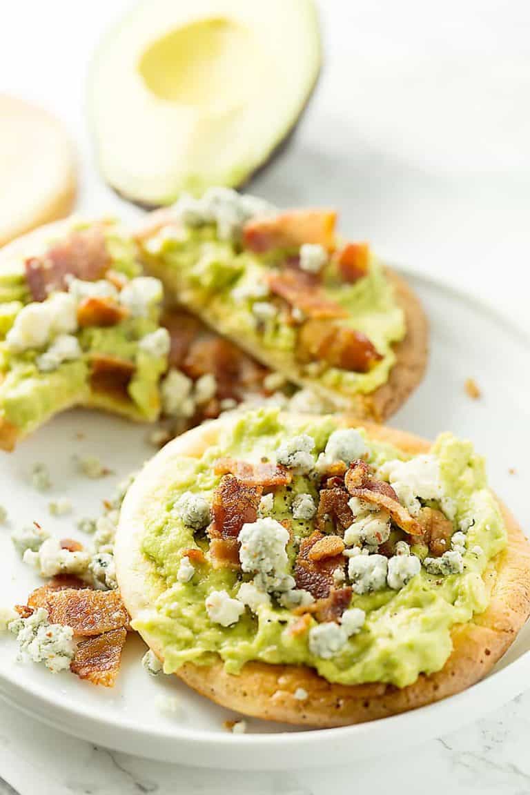 mashed avocado on oopsie rolls with bacon and blue cheese on top