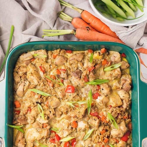 chicken cauliflower fried rice casserole in a green casserole dish