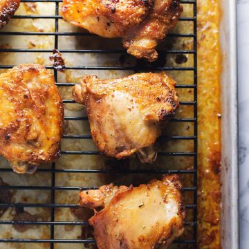 crispy chicken thighs recipe on a baking rack