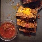 cheese stuffed meatloaf on a sheet pan with salsa