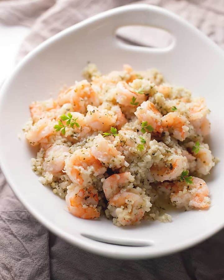 garlic butter shrimp with cauliflower rice in a white bowl