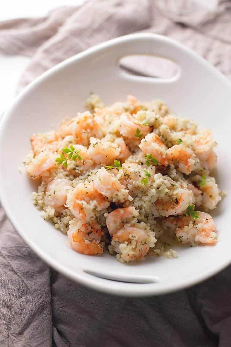 garlic butter shrimp with cauliflower rice in a white bowl