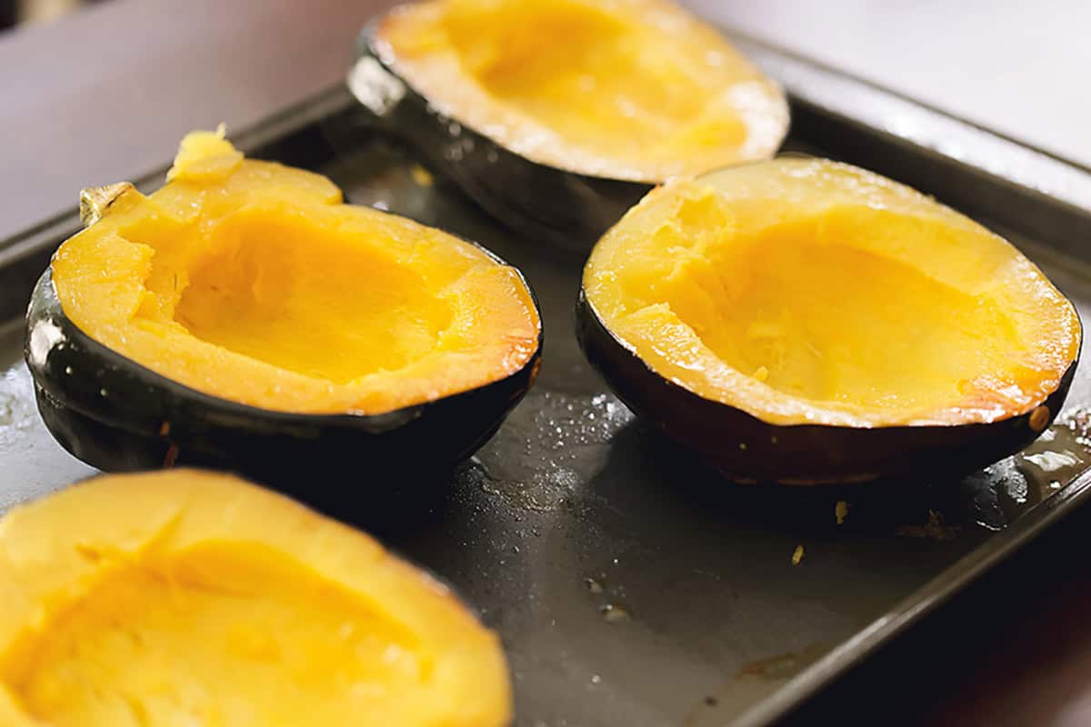 acorn squash roasted on a sheet pan