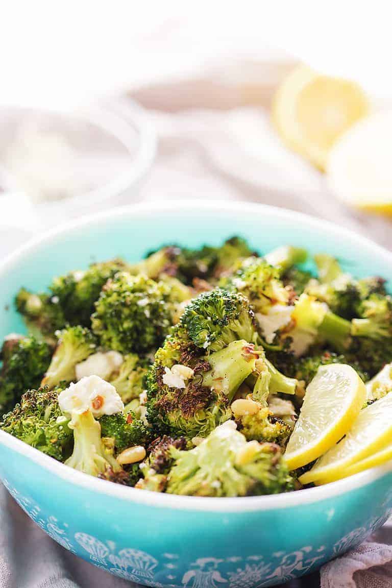 charred broccoli in a blue bowl