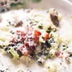 a bowl of Zuppa Toscana with crispy bacon on top