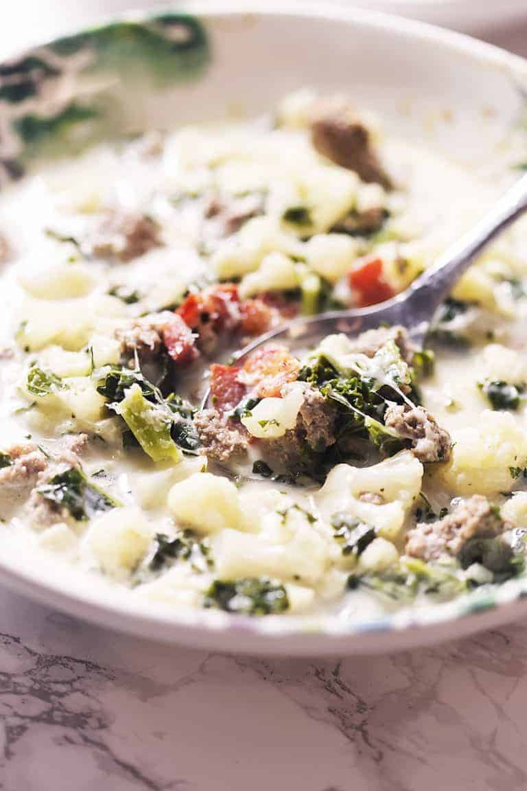 a bowl of low carb zuppa toscana soup with a spoon