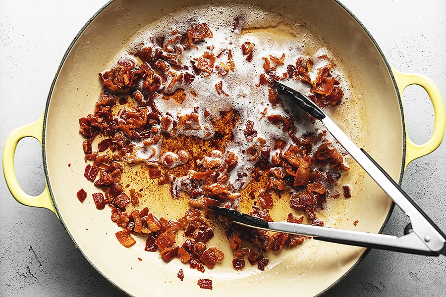 bacon cooking in a big skillet