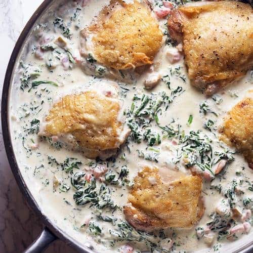 keto chicken thighs and creamy spinach in a skillet