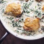 chicken thighs and creamy spinach in a skillet
