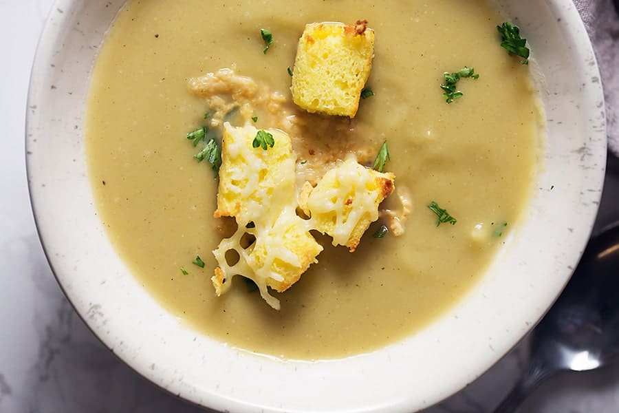 A bowl of acorn squash soup with croutons