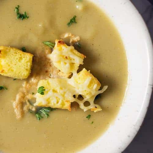 A bowl of acorn squash soup with croutons
