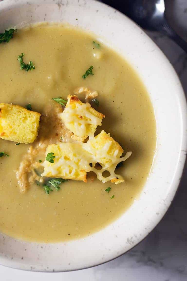 A bowl of acorn squash soup with croutons