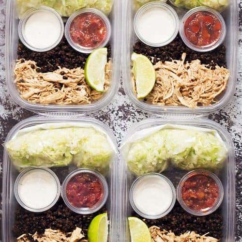 meal prep containers with lettuce, black lentils, chicken breast, sour cream, and salsa