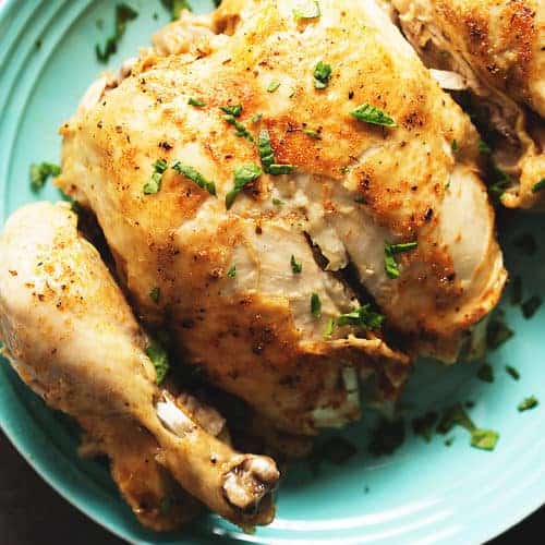 a whole roast chicken on a blue plate