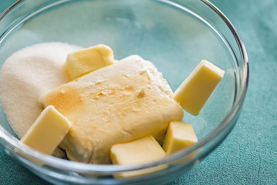 sugar, butter, cream cheese, and vanilla in a glass bowl