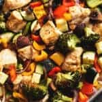a sheet pan with cooked chicken and veggies