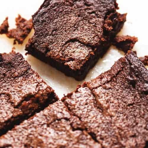 keto brownies cut on a piece of parchment