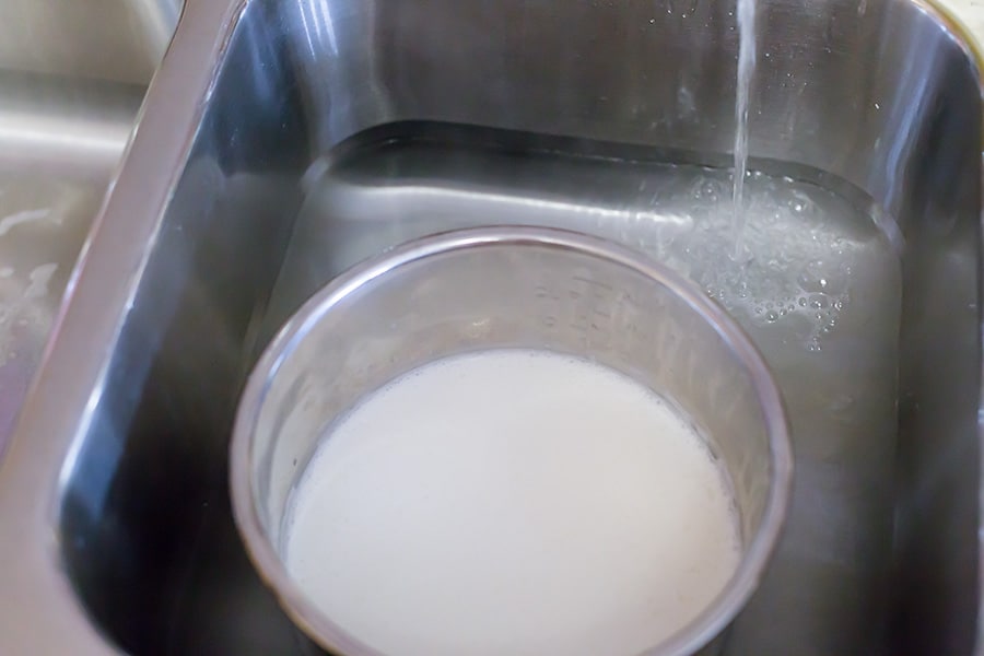 Milk being cooled in the instant pot in a sink with water