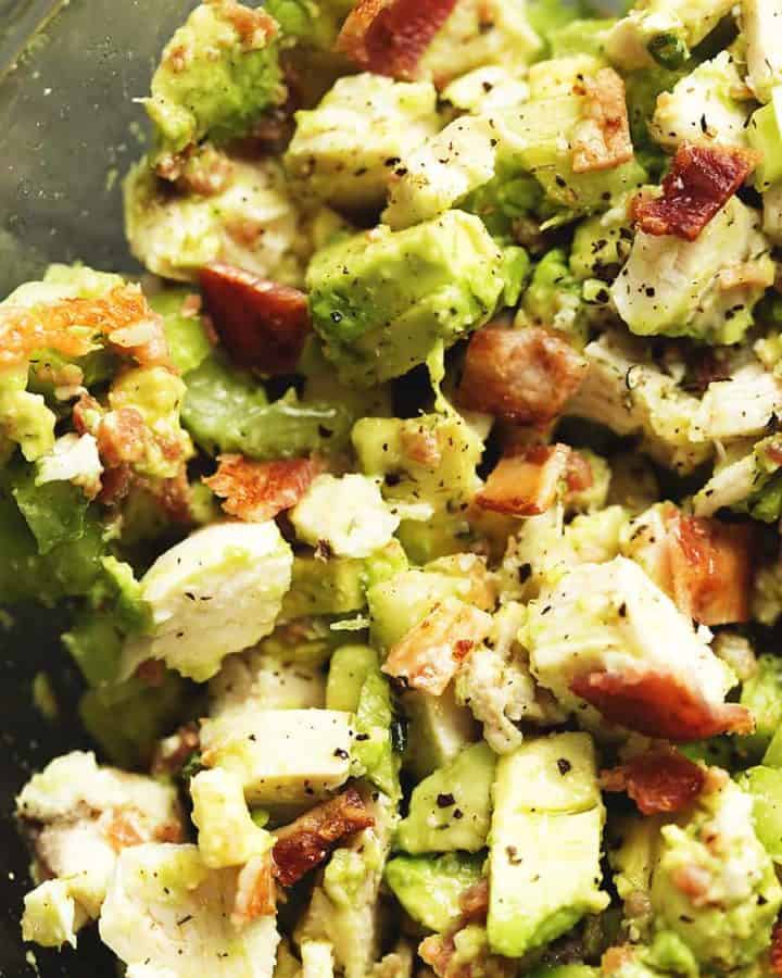a close up shot of chicken salad with avocado and bacon