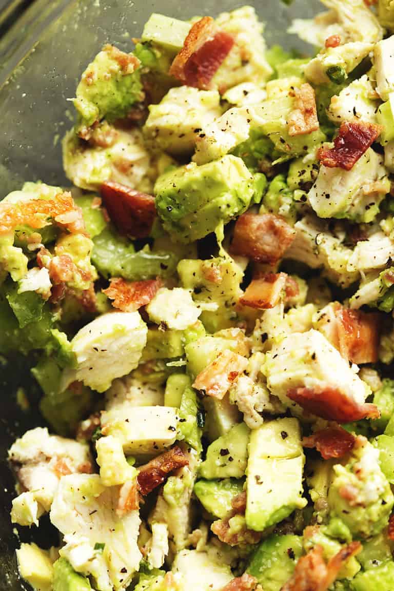a close up shot of chicken salad with avocado and bacon