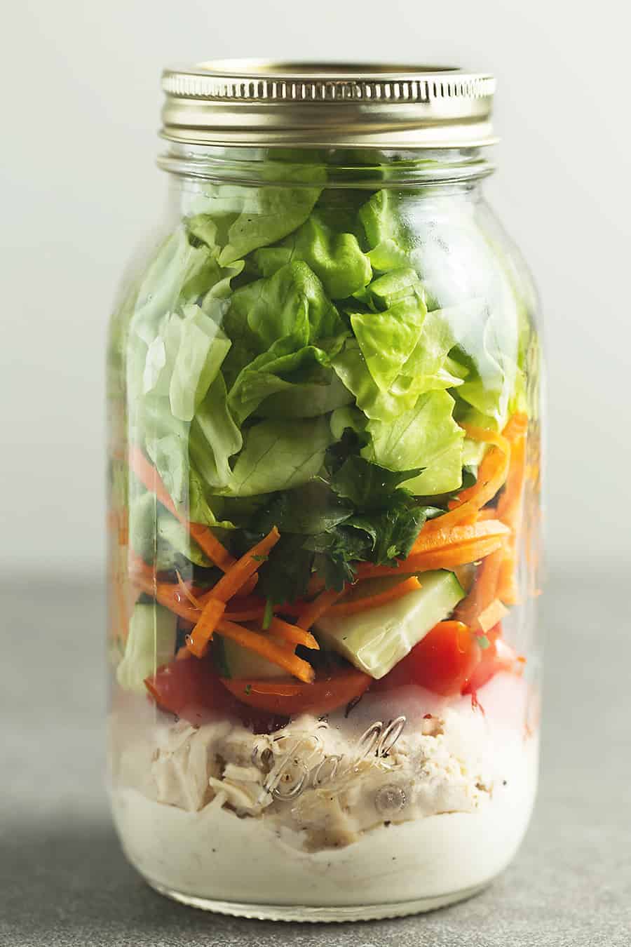 a mason jar with salad in it