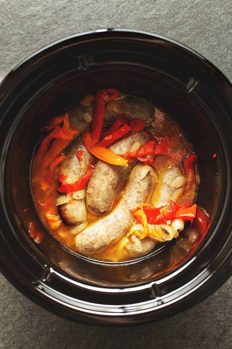 sausage and peppers in a black crock pot