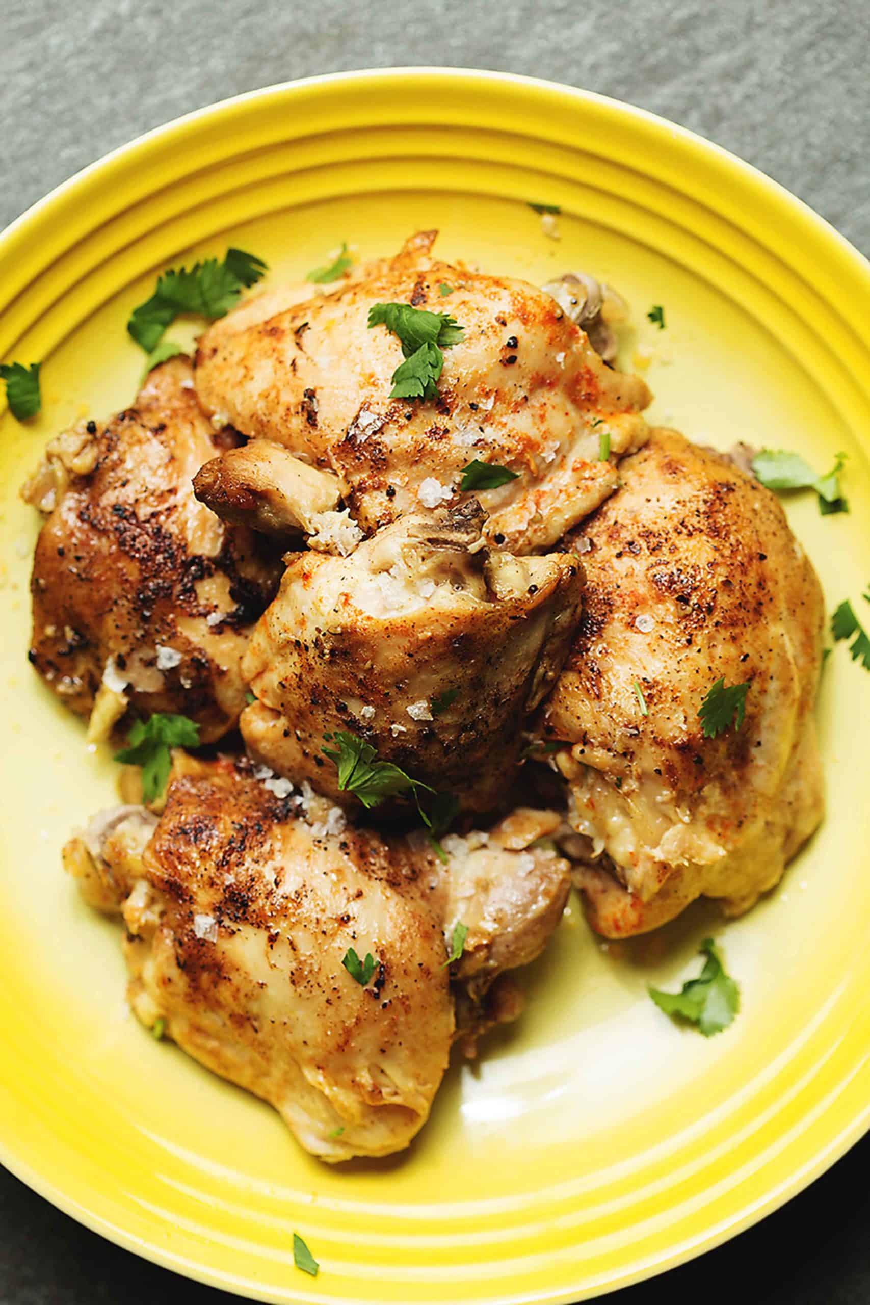 chicken thighs in a yellow bowl