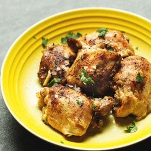 chicken thighs on a yellow plate