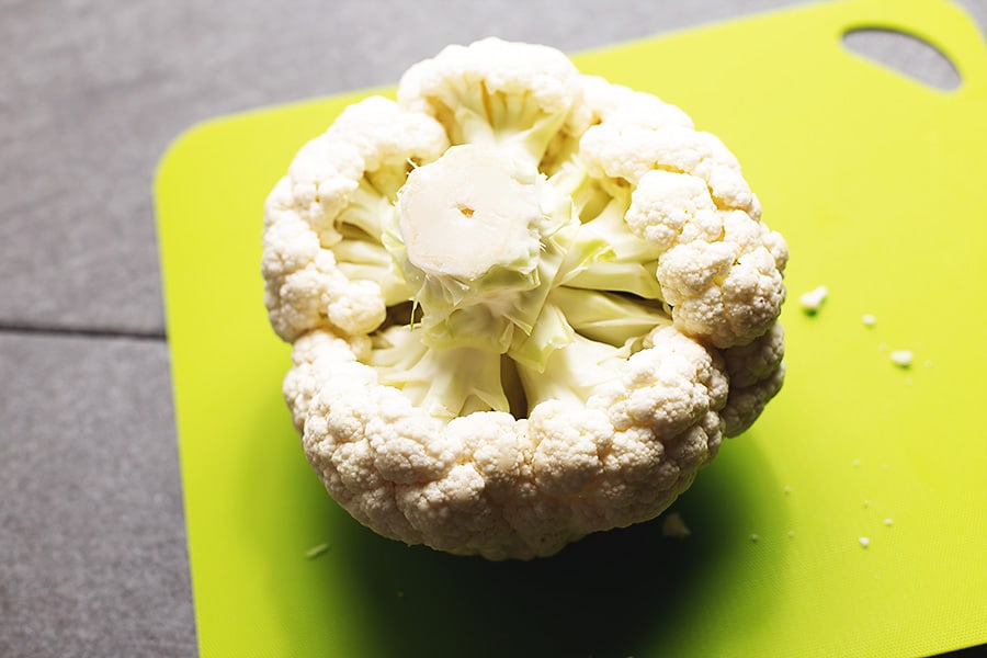 large head of cauliflower on a green cutting board