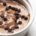 chocolate protein pudding with chocolate chips in a white ramekin
