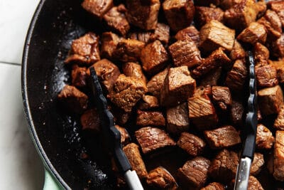 steak bites recipe with tongs