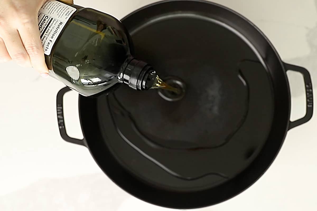 pouring avocado oil into a pan