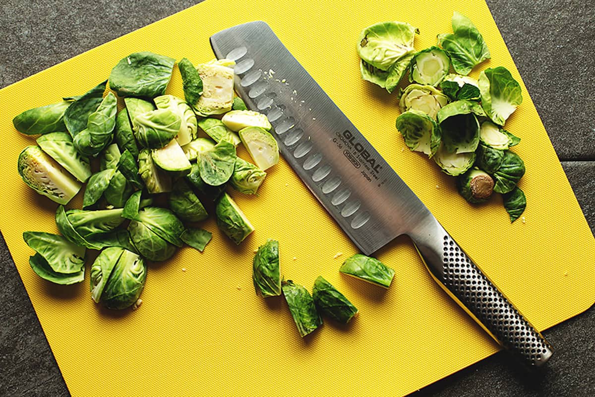 prepping brussel sprouts in a cutting board