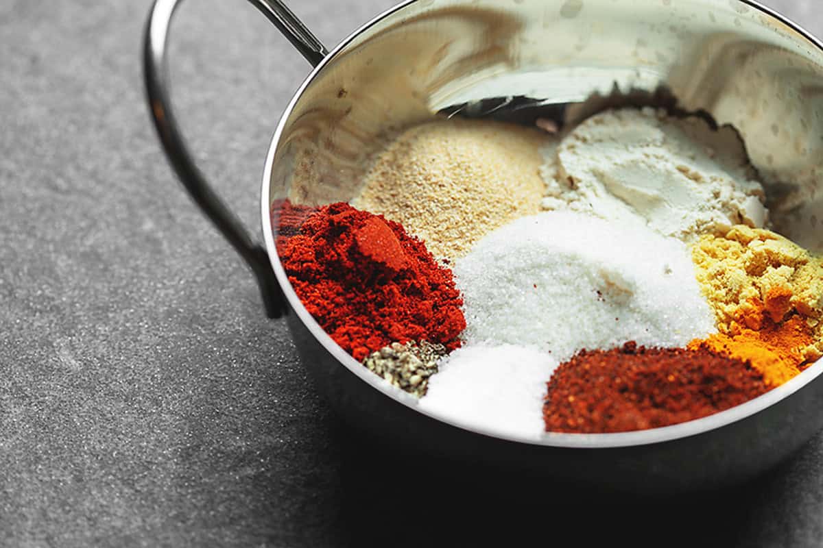 Ingredients for homemade BBQ rib rub in a metal mixing bowl