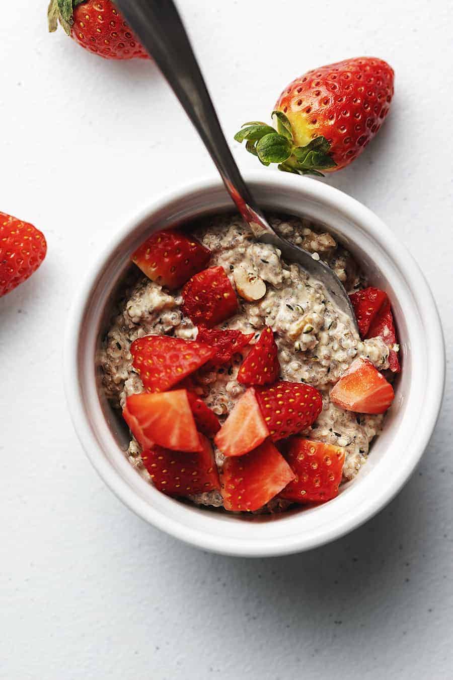 keto oatmeal in a white bowl with chopped strawberries