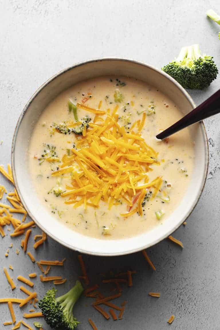 keto broccoli cheese soup with a spoon in a gray bowl