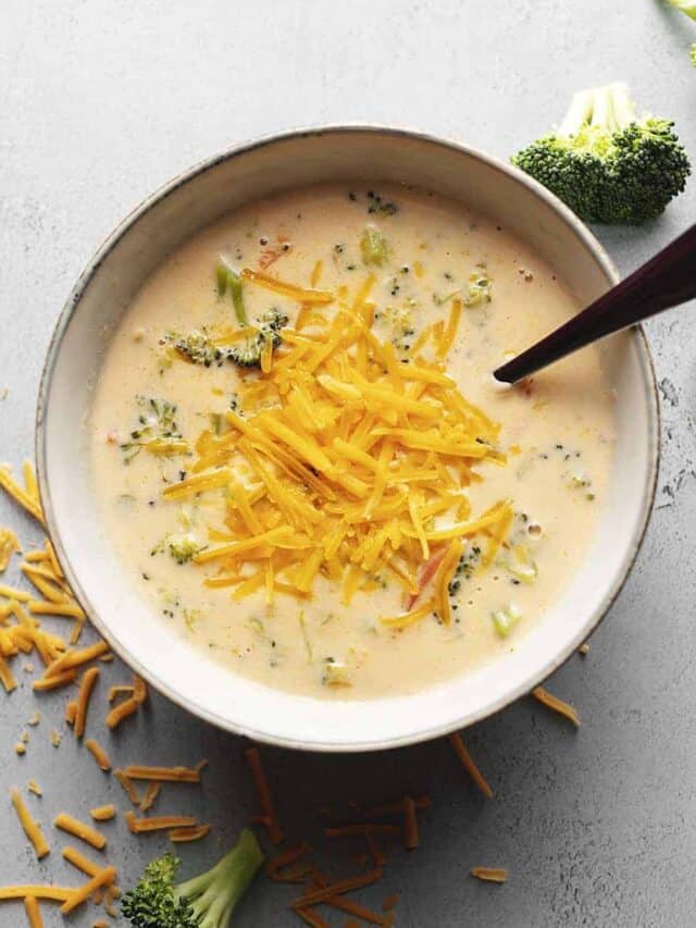 keto broccoli cheese soup with a spoon in a gray bowl
