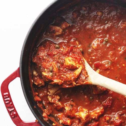 chicken cacciatore stew in a red dutch oven