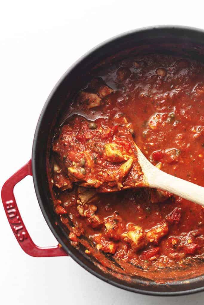 chicken cacciatore stew in a red dutch oven