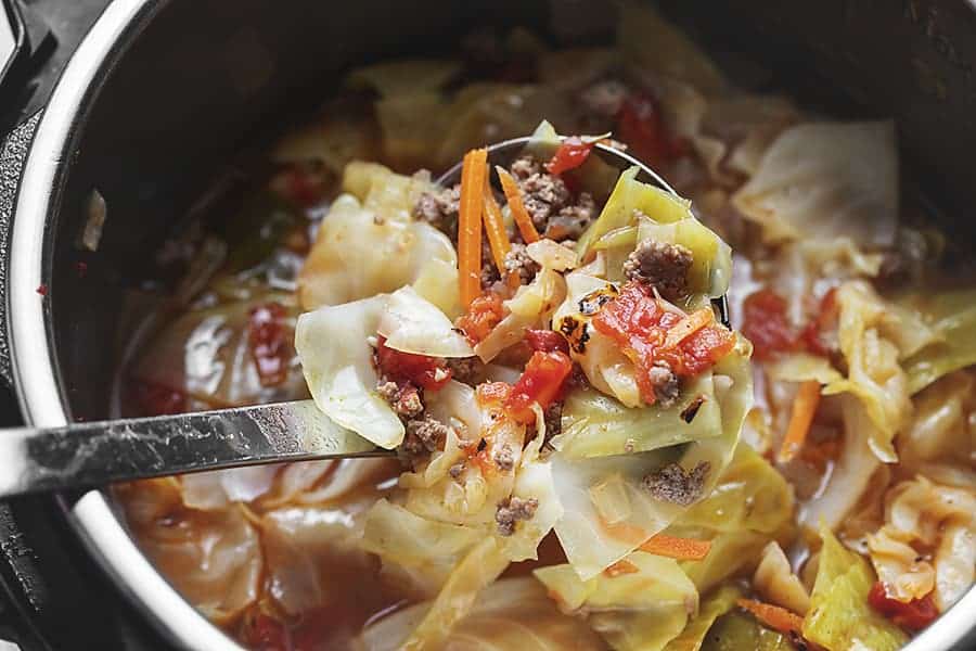A ladle of unstuffed cabbage soup in an instant pot