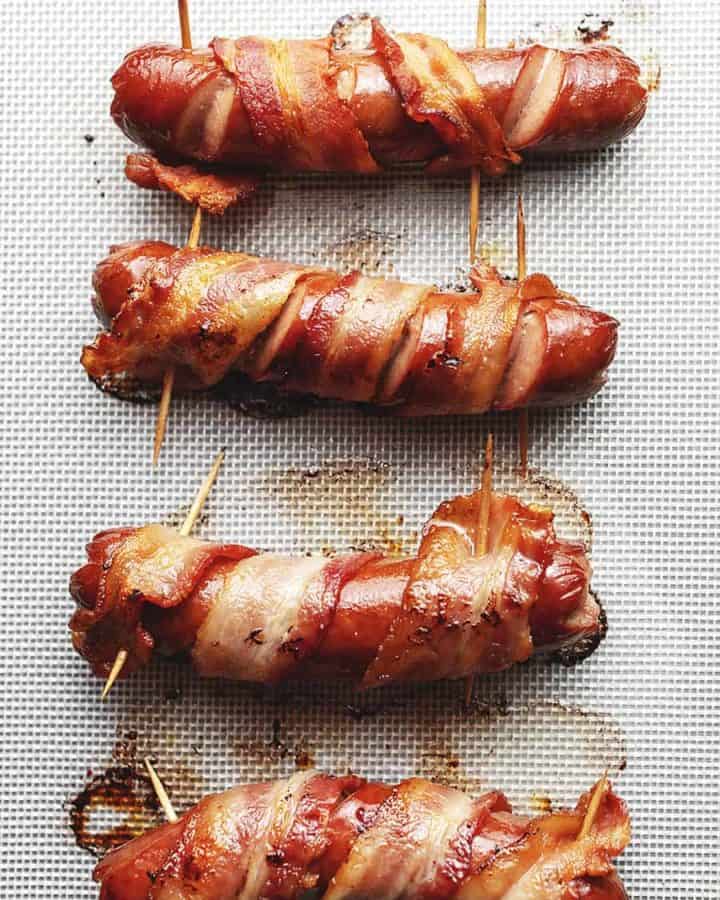 bacon wrapped hot dogs on parchment paper